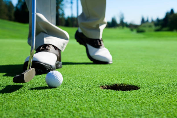 golfspieler zapfen in - putting green stock-fotos und bilder