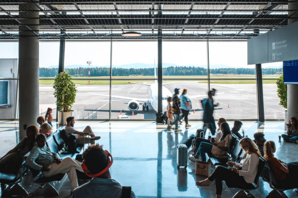 istock Diverse People Casually Waiting At Departures Terminal 1573789682