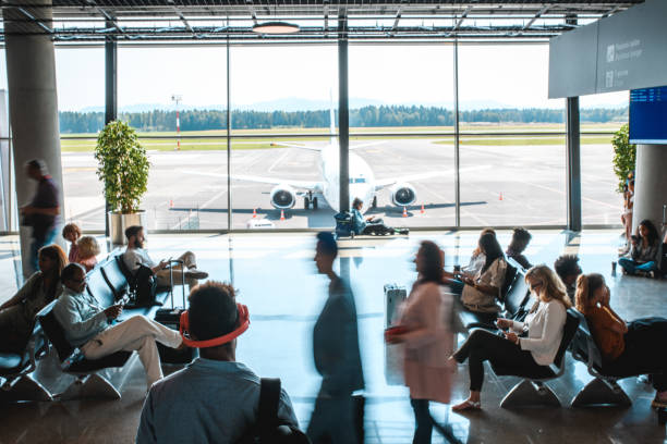 istock Diverse People Casually Waiting At Departures Terminal 1573789771