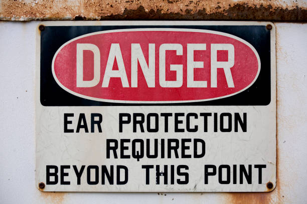 istock Old, rusty red, black, and white ear protection danger sign. 157379146