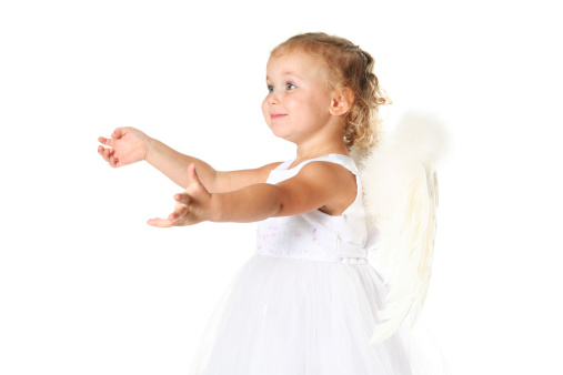 Ideas and fantasies. Cute little girl, child in image of angel sitting with smile isolated over white studio background. Concept of childhood, imagination, fantasy, fashion and beauty, holidays. Body