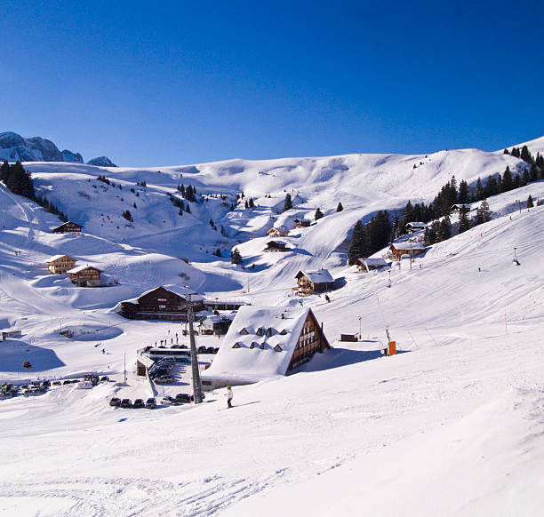 Scenic landscape with ski slope at Swiss ski resort Flumserberg on a foggy late winter day. Photo taken March 16th, 2025, Flumserberg, Switzerland.