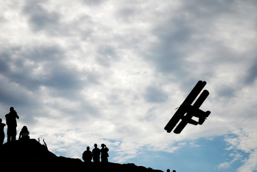 An old biplane flies over people in Yellowknife in Canada's Northwest Territories.