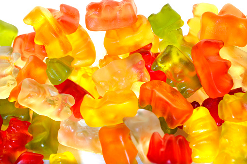 Assortment of colorful fruity Gummy Bears isolated on white background