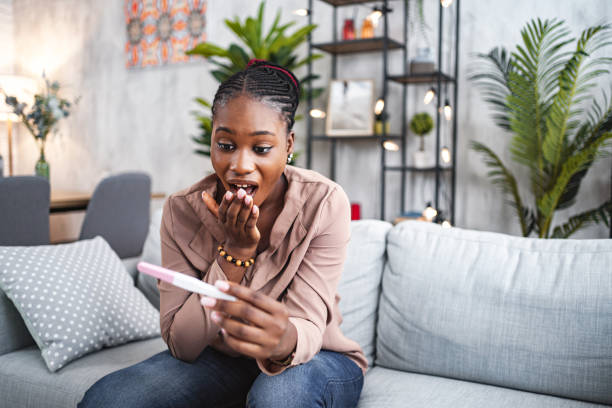 istock Black woman feeling excited after doing a pregnancy test 1573800937