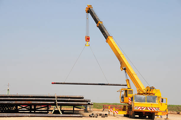 lifting crane - derrick crane stock-fotos und bilder