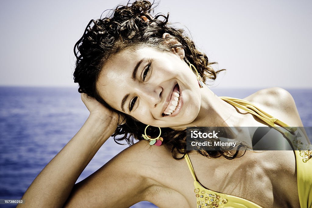 Summer Beauty Portrait Beautiful young woman relaxing with a relaxed senusal glance, Blue summer sky and ocean unsharp in the background. Woman Portrait. Bikini Stock Photo