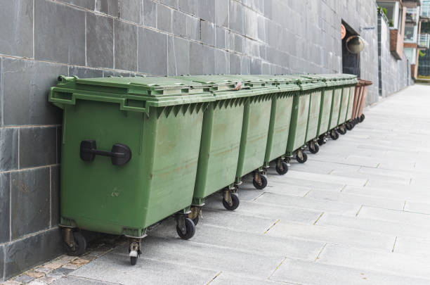 istock Recycling bins in a row in front of a wall 1573803710