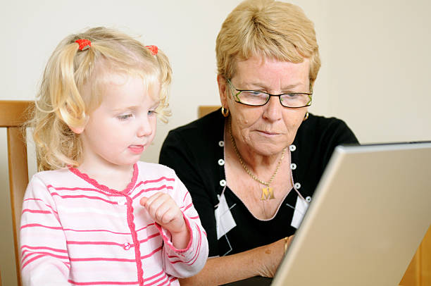 istock grandma and grandaughter using laptop 157380390