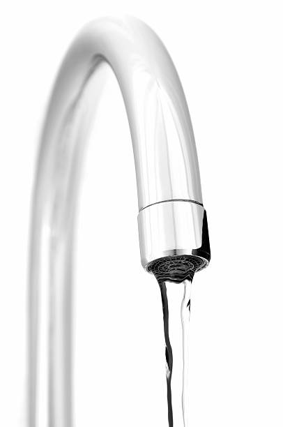 istock Water pouring from the kitchen tap, isolated on white 157380401