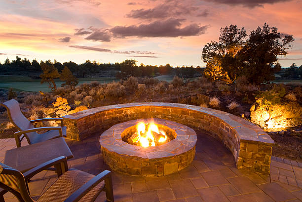 Stone Fire Pit stone fire pit with outdoor chairs, enjoying the sunset and landscape. fire pit photos stock pictures, royalty-free photos & images
