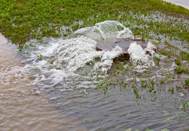 manhole cover bubbles over  manhole stock pictures, royalty-free photos & images