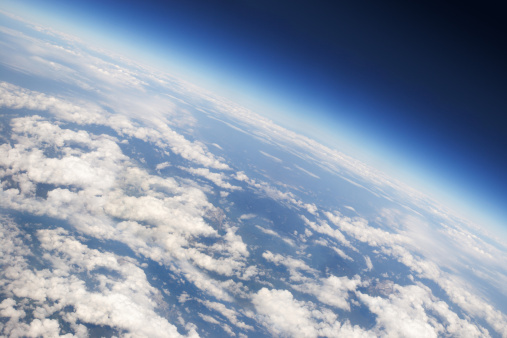 Image from airplain of planet Earth with clouds, horizon and little bit of space, make feelings of being in heaven.
