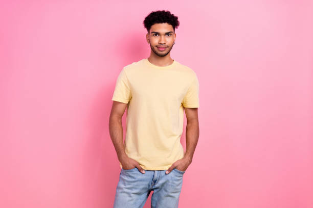 Photo portrait of funny young handsome guy model hold hands jeans pockets wear shirt isolated pink color background