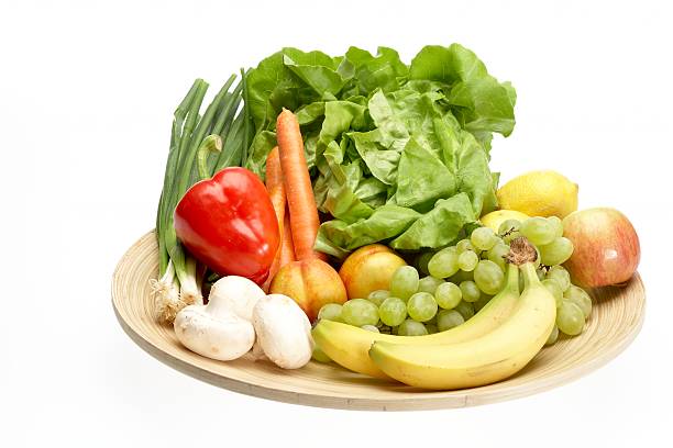 Fresh fruit and vegetables on round plate