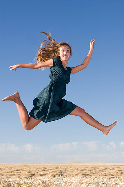 istock Young Woman Leaping through Air 157381103