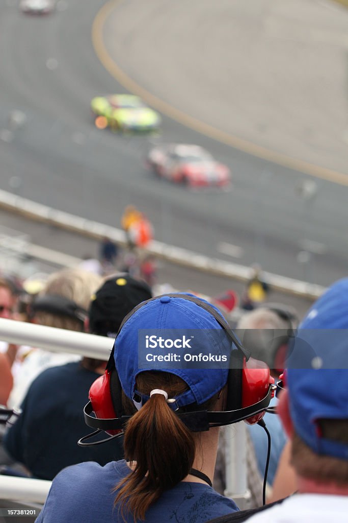 Woman Fan at Racing Event and Looking at Race Woman fan at racing event and looking at motor racing track. Stock Car Stock Photo