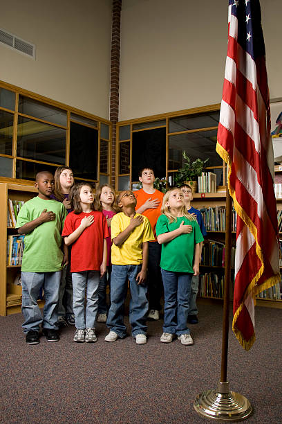 istock Young American students pledging allegiance to the flag 157381377