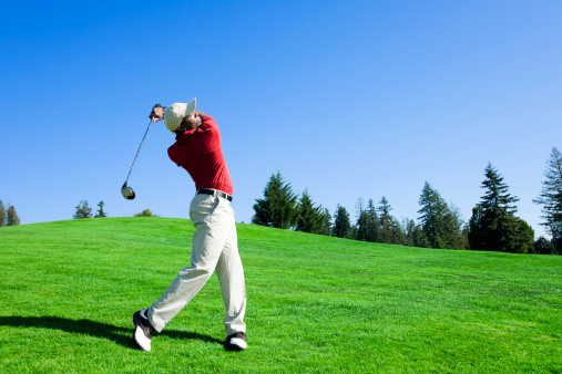 Golf course panorama at sunset with beautiful sky. Scenic panoramic view. Golf course with pine trees.