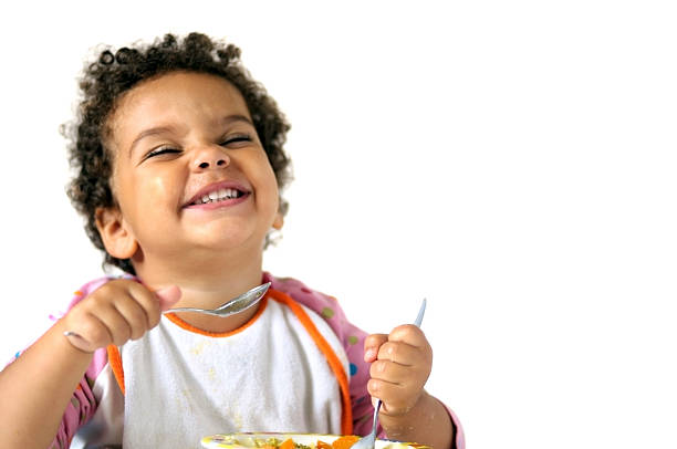 Child eating isolated against white background