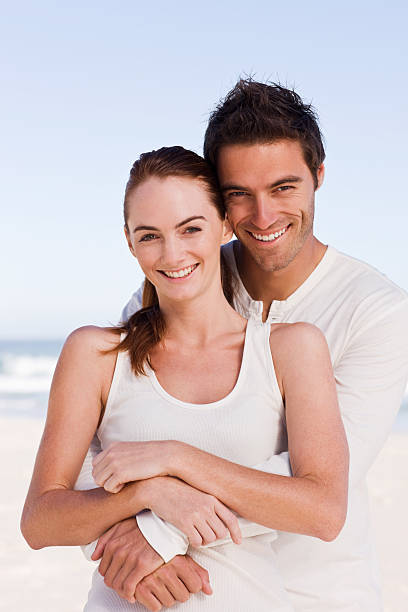istock Happy young couple embracing each other at beach 157381814