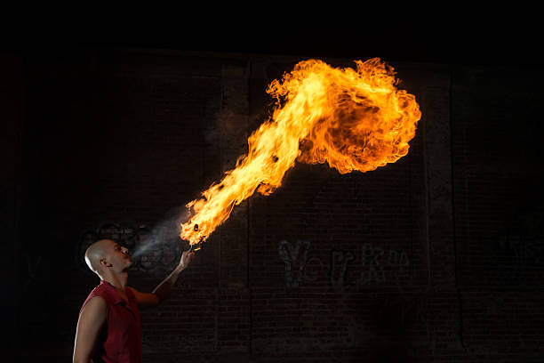 istock Street Performer Fire Breather Blowing on Torch 157382040
