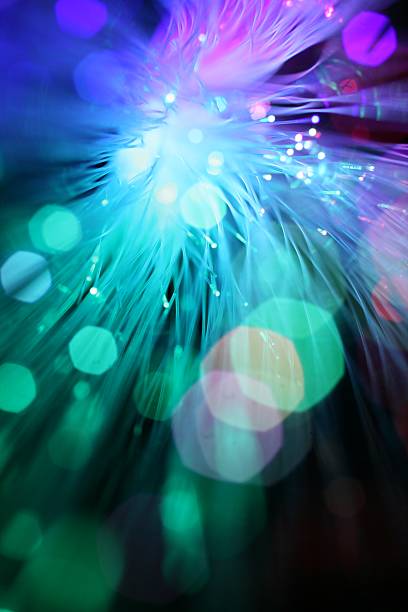 Close-up bokeh of optical fibers in purple and teal stock photo
