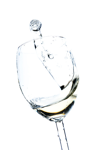 Cheers, single glass of white wine with splash, isolated on white, studio shot.