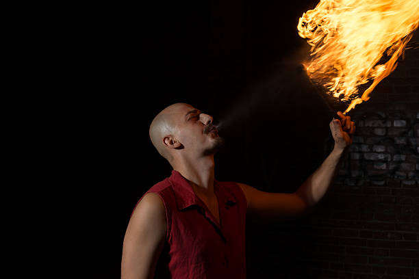 istock Street Performer Fire Breather Blowing on Torch 157382763