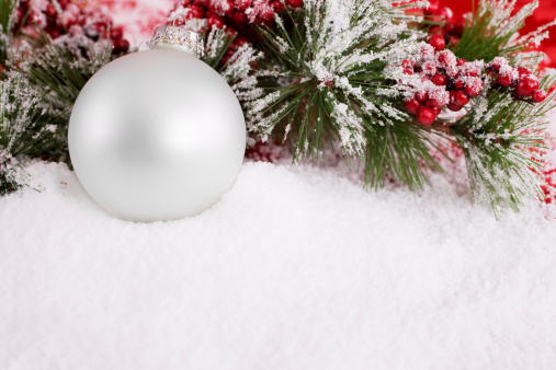 Christmas snow covered tree and red ball, close up. Winter season, cold and snow falling. Holiday greeting card. 3d render