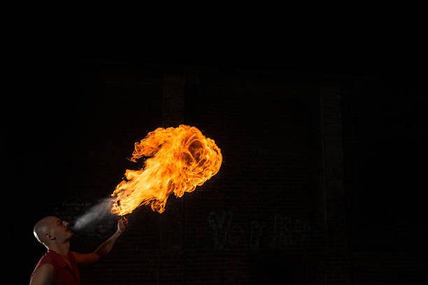 istock Street Performer Fire Breather Blowing on Torch 157383054