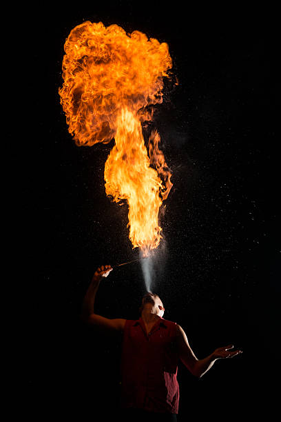 istock Street Performer Fire Breather Blowing on Torch 157383056