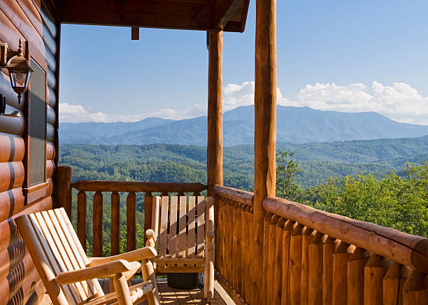 Rocking chairs on the patio outside a mountain cabin Rocking chairs invite relaxation with a view of the Smoky Mountains. great smoky mountains photos stock pictures, royalty-free photos & images