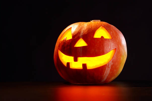 istock A picture of a lit pumpkin on a black background 157383147