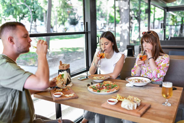 istock Friends Enjoying Cocktails And Beer During Dinner 1573832554