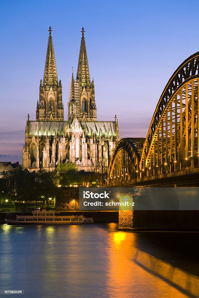 Cologne cathedral and the Hohenzollern bridge at twilight Cologne Cathedral and Hohenzollern Brigde in twighlight.  Cologne Cathedral Stock Photo