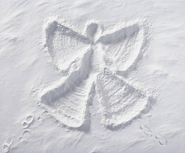 Snow Angel Snow Angel with foot prints in snow. Photographed from directly above. snow angels stock pictures, royalty-free photos & images