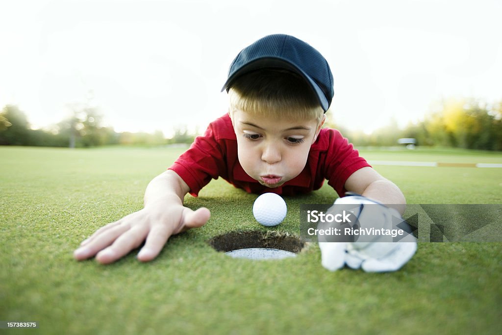 Get In the Hole! Sometimes you just need to give it a little help. Golf Stock Photo
