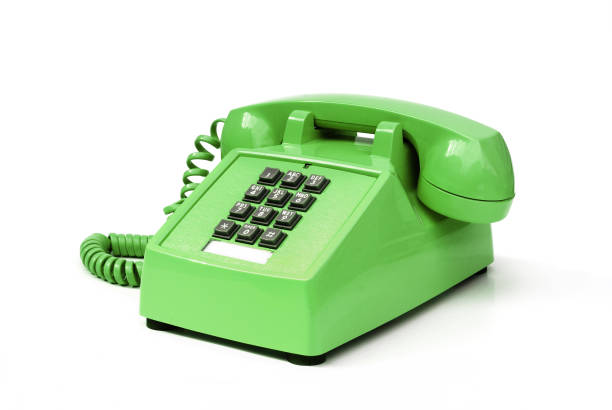 Funky green vintage pushbutton phone Funky green retro 80's push button office phone. landline phone stock pictures, royalty-free photos & images
