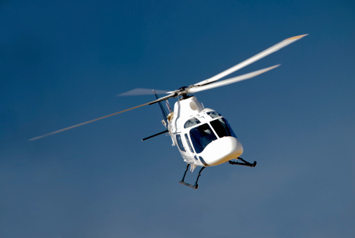 Small helicopter in flight. Helicopter for two people concept