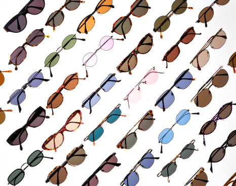 colorful stylish fashion tinted sunglasses diagonal arranged on white background