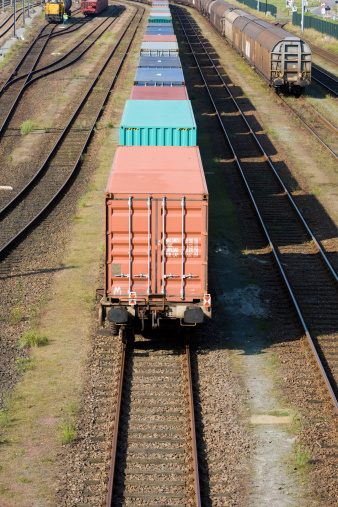 Train with colorful containers in the sunlight