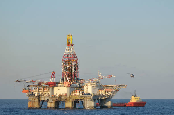 istock Off shore oil rig with helicopter and supply boat. 157384019
