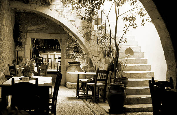 istock Romantic restaurant interior in Greece, wooden tables, chairs, sepia toned 157384104