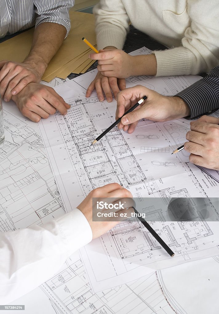 All hands to work Macro of hands on blueprints Architect Stock Photo