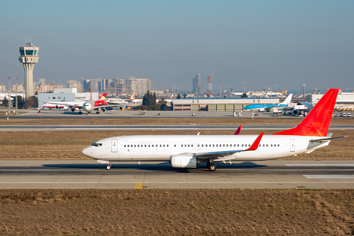 Passenger plane taking off. A passenger plane taking off at a major airport. A sunny day. Istanbul airport. There are no people.