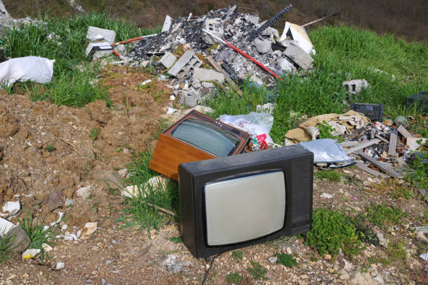 istock Old retro television set at a junkyard. Broken TV with garbage dump, environmental pollution 1573850968
