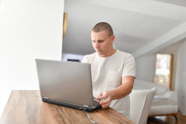 Male Freelancer Turning On Laptop To Work At Home
