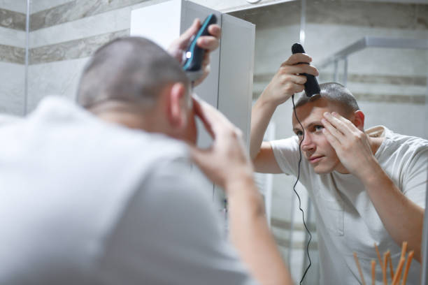istock Male Shaping His Buzz Cut In Mirror 1573864344