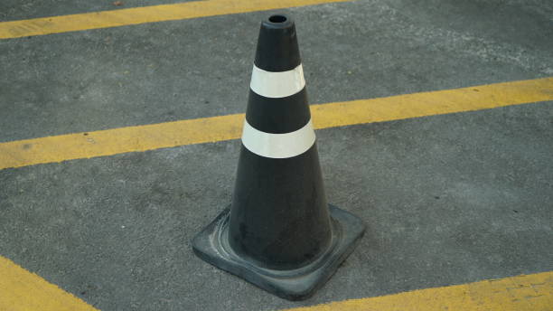istock Black and white striped traffic cones 1573882528